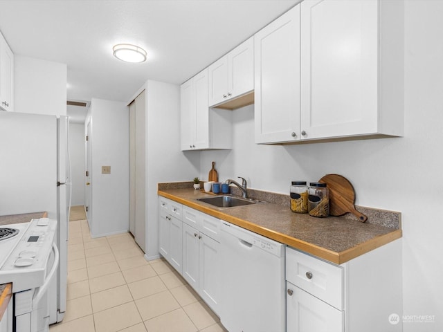 kitchen featuring white cabinets, light tile patterned floors, sink, and white appliances