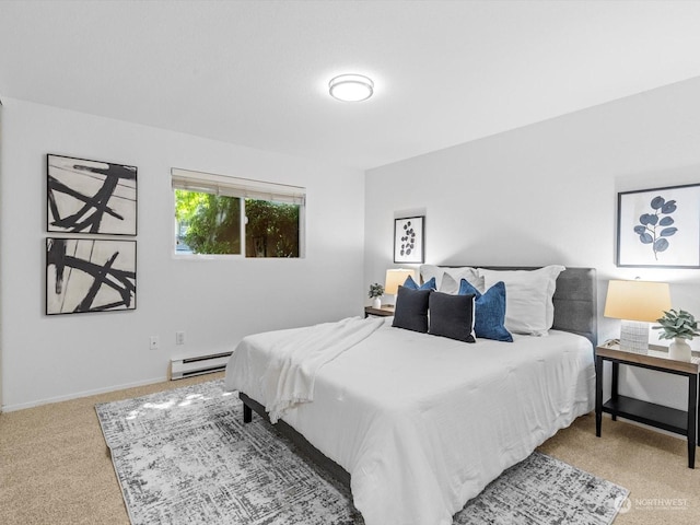 bedroom with carpet floors and a baseboard heating unit