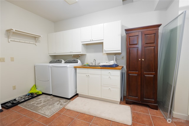 washroom with tile patterned flooring, cabinets, sink, and independent washer and dryer