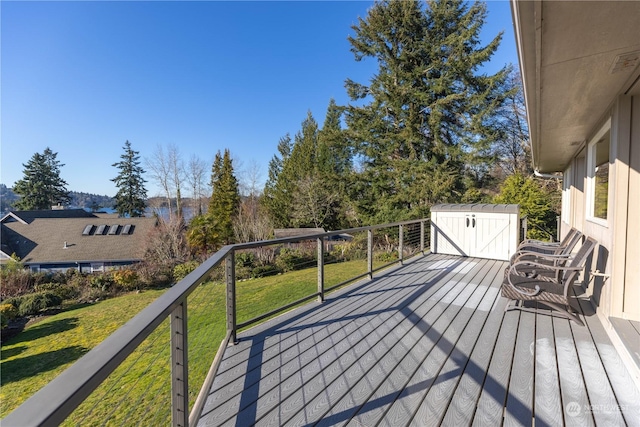 wooden deck featuring a lawn and a shed