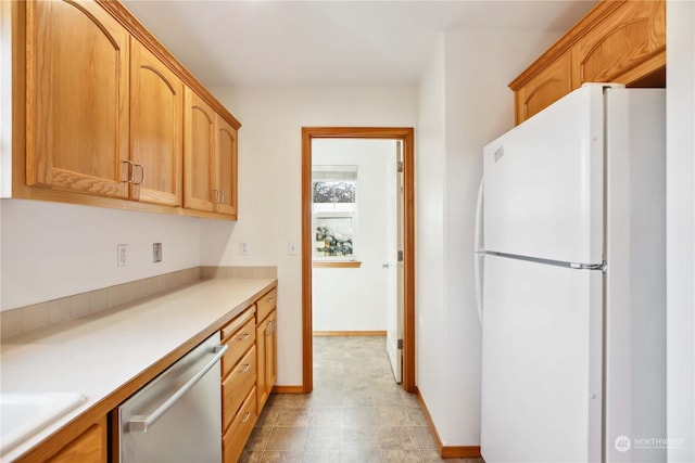 kitchen with dishwasher and white fridge