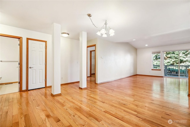 unfurnished living room featuring light hardwood / wood-style flooring and a chandelier