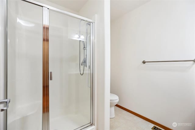 bathroom featuring toilet and walk in shower