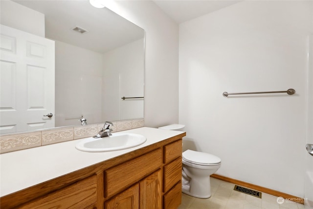 bathroom featuring toilet and vanity