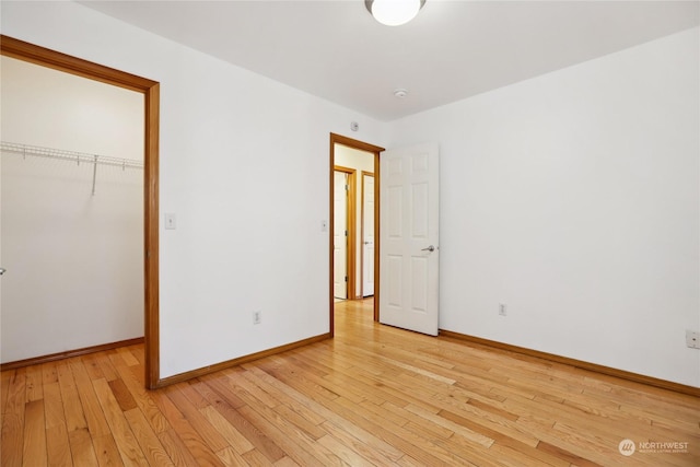 unfurnished bedroom featuring a closet and light hardwood / wood-style flooring