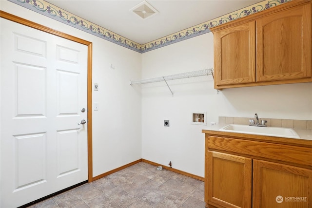 clothes washing area featuring cabinets, sink, electric dryer hookup, and hookup for a washing machine