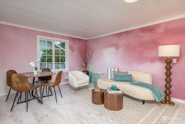 sitting room featuring wood-type flooring and crown molding