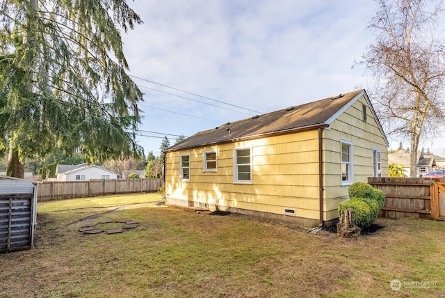 rear view of property with a yard