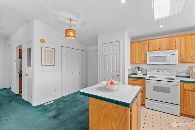 kitchen with decorative light fixtures, a kitchen island, white appliances, and light carpet