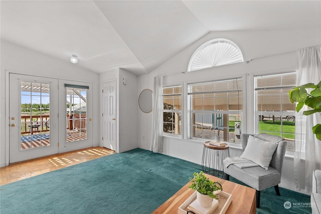 sitting room with carpet floors, a wealth of natural light, and lofted ceiling