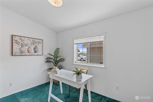 carpeted office space with vaulted ceiling