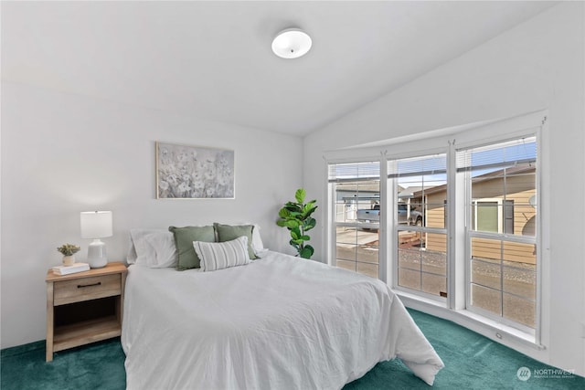 carpeted bedroom featuring lofted ceiling