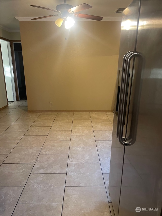 interior space featuring crown molding and light tile patterned floors