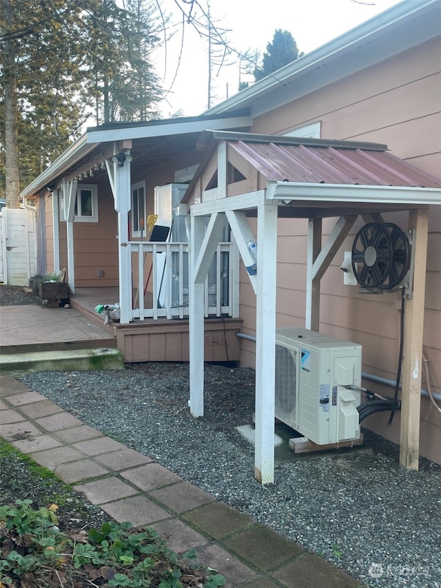 view of patio featuring ac unit and a deck