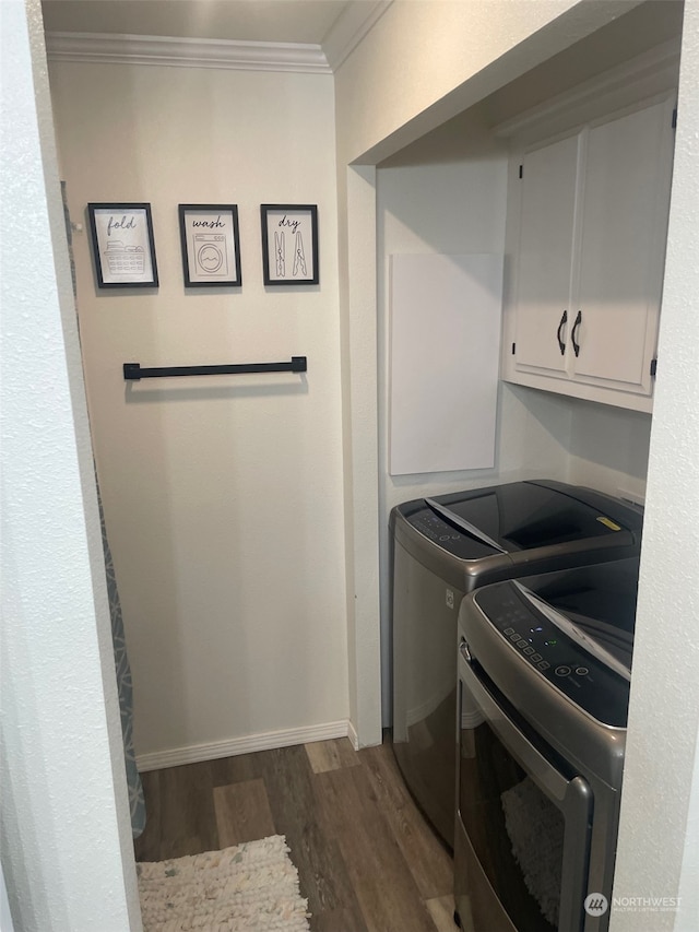 laundry area featuring ornamental molding, dark hardwood / wood-style flooring, cabinets, and independent washer and dryer