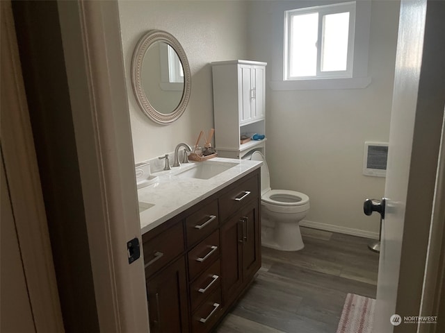 bathroom with hardwood / wood-style floors, vanity, and toilet