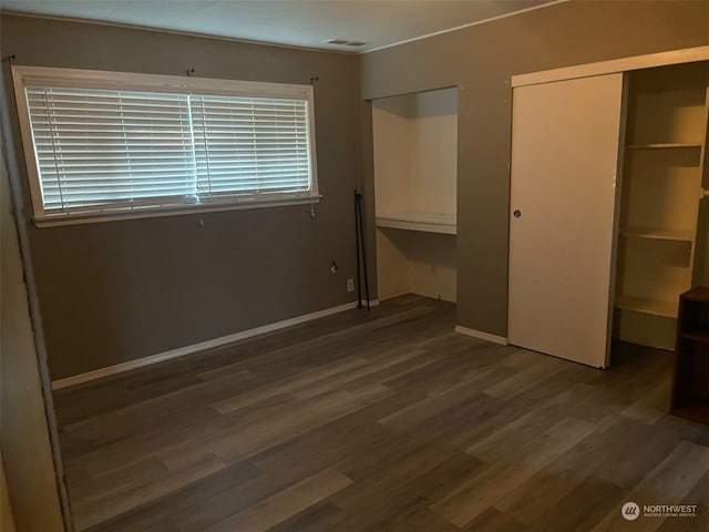 unfurnished bedroom featuring dark wood-type flooring