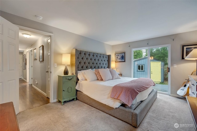 bedroom with access to outside and carpet floors