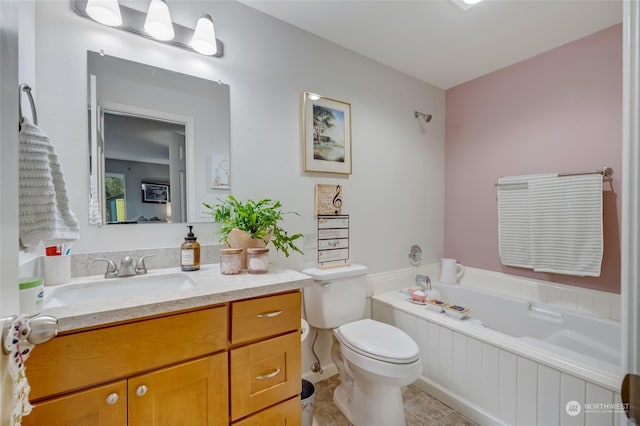 bathroom with a bath, vanity, toilet, and tile patterned floors