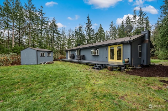 back of property featuring a lawn, a wooden deck, and a storage unit