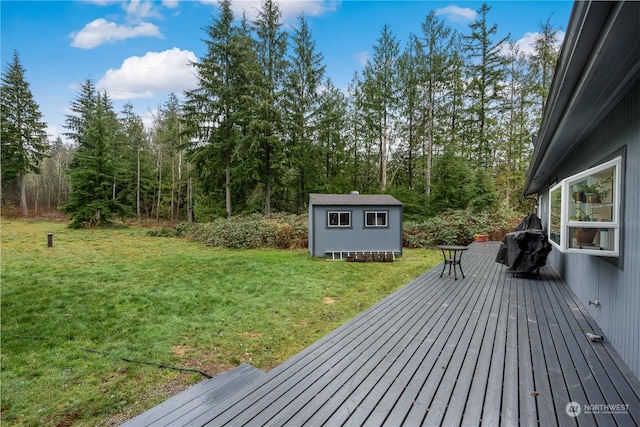 wooden terrace featuring a yard and a storage shed