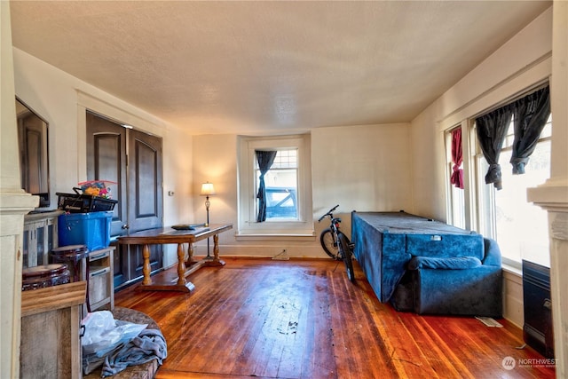 interior space with dark hardwood / wood-style floors and a textured ceiling