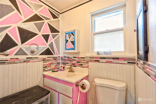 bathroom featuring radiator heating unit, toilet, vanity, and crown molding