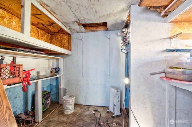 basement featuring radiator heating unit