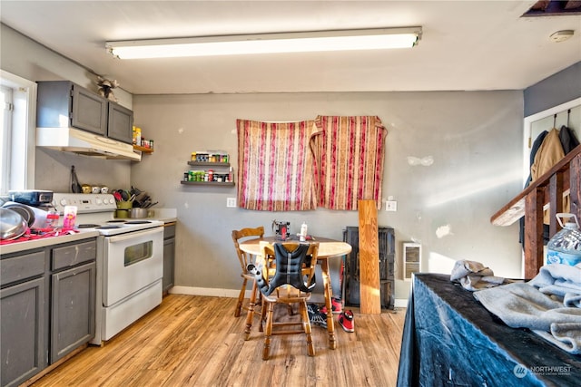 kitchen with white electric range, light hardwood / wood-style flooring, and gray cabinetry