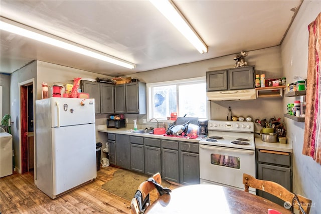 kitchen featuring sink, gray cabinets, white appliances, and light wood-type flooring