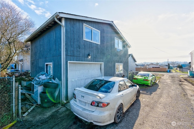 view of side of home featuring a garage