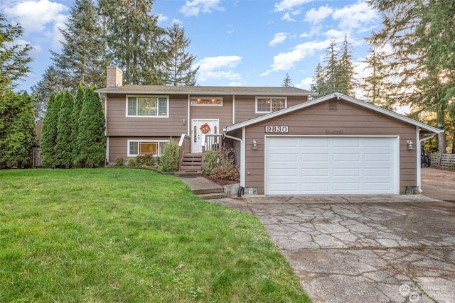 bi-level home with a front yard and a garage