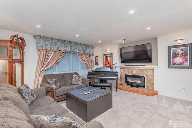 carpeted living room featuring a textured ceiling and a tiled fireplace