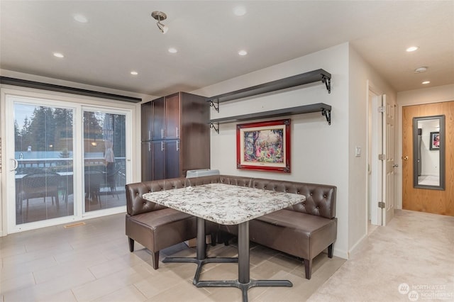 dining space with wooden walls and breakfast area