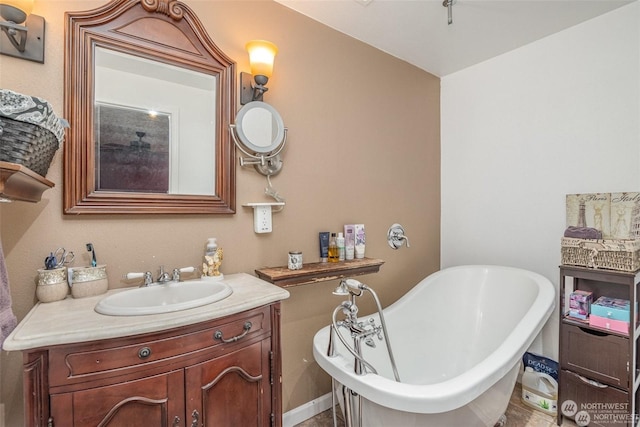 bathroom with a tub and vanity