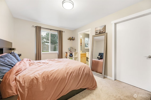 carpeted bedroom featuring ensuite bathroom