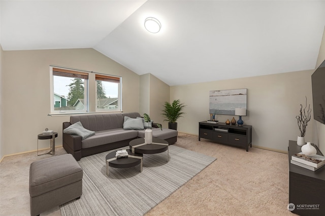 carpeted living room featuring lofted ceiling