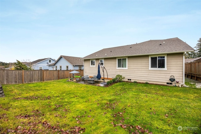 back of house featuring a lawn and a patio