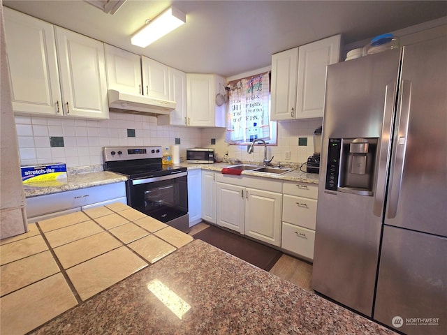 kitchen with white cabinets, stainless steel appliances, tasteful backsplash, and sink