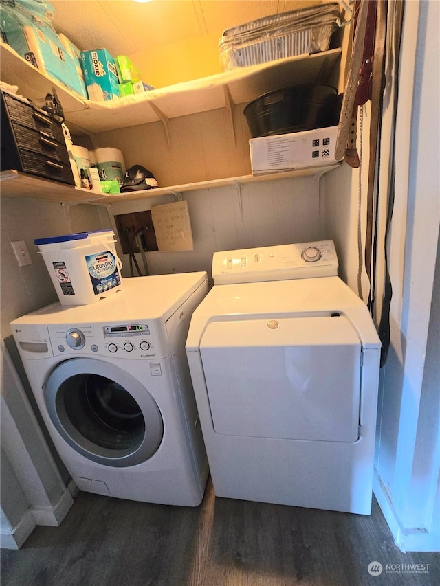 laundry room with independent washer and dryer and dark hardwood / wood-style flooring