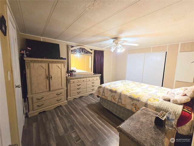 bedroom featuring ceiling fan and dark wood-type flooring