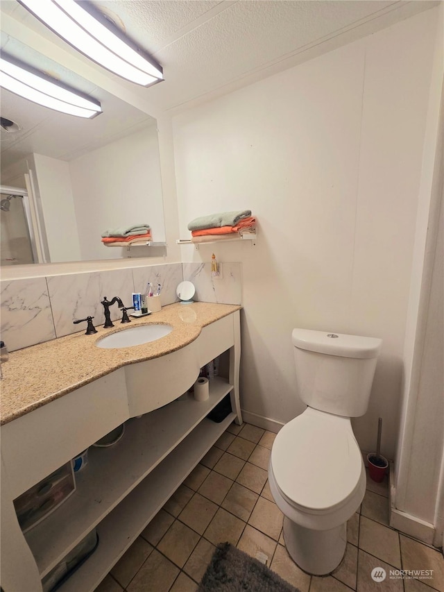 bathroom with sink, backsplash, tile patterned floors, a textured ceiling, and toilet