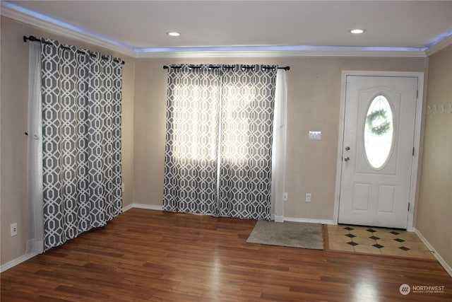 foyer entrance featuring baseboards, ornamental molding, dark wood-type flooring, and recessed lighting