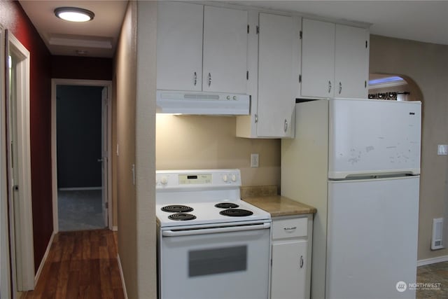 kitchen with dark wood-type flooring, white appliances, and white cabinets