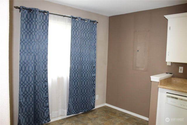 interior space featuring electric panel and baseboards