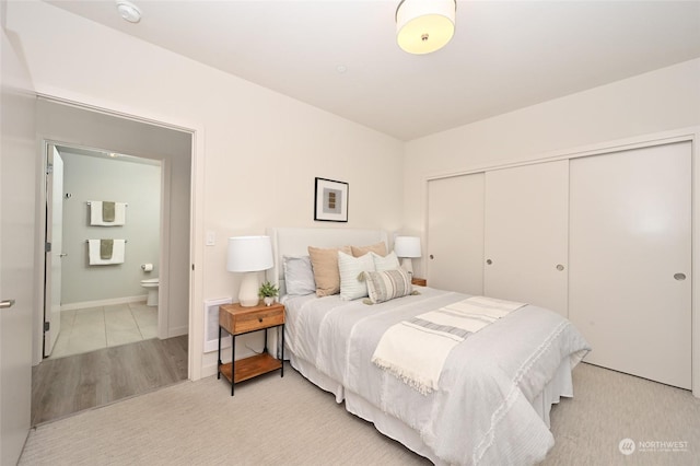 bedroom featuring a closet and ensuite bath