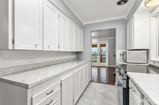 kitchen featuring white cabinets, light stone countertops, electric stove, and crown molding