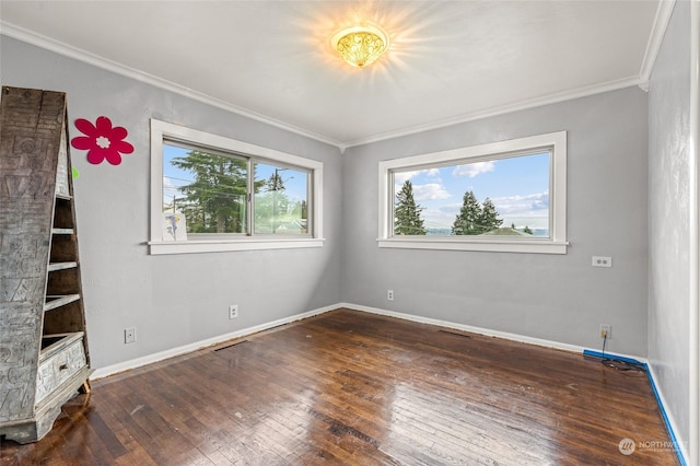 unfurnished room with ornamental molding and dark wood-type flooring