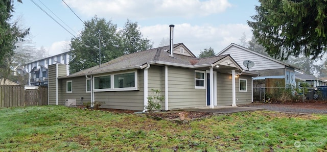 rear view of house with a yard