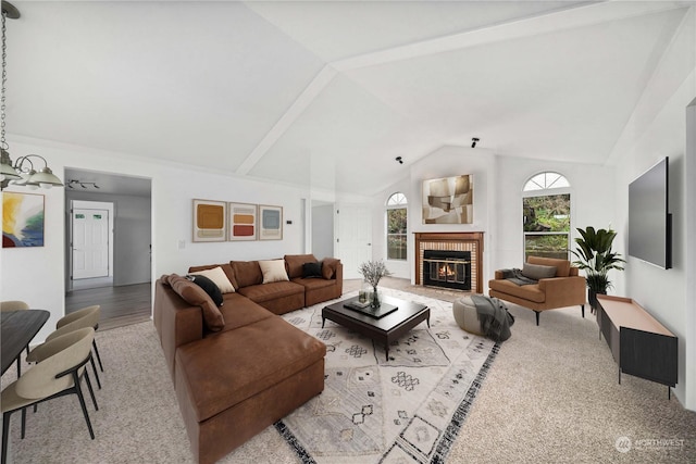 living room featuring lofted ceiling, a fireplace, and wood-type flooring